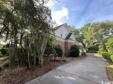 View of side of property featuring brick siding