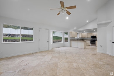 Unfurnished living room featuring recessed lighting, high vaulted ceiling, and a ceiling fan