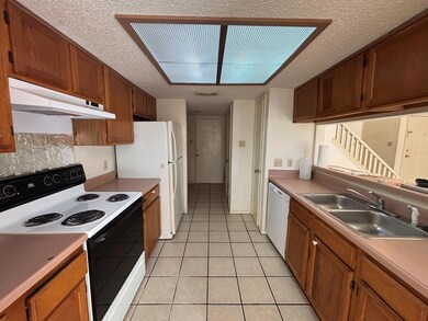 Kitchen with white appliances, under cabinet rang