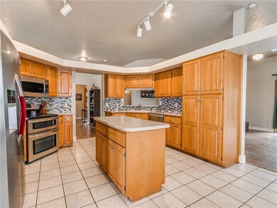 The open kitchen with stainless steel appliances c