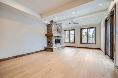 Living room with stone surround fireplace.