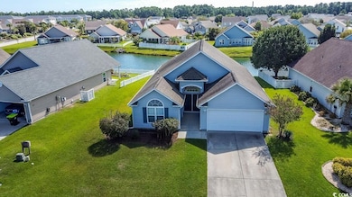 Aerial perspective of suburban area featuring a nearby body of water