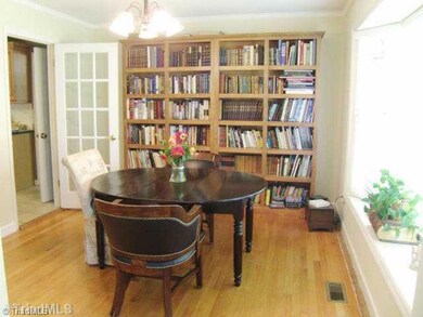 Dining Room. Spacious Dining Room with real hardwood floors, window seat, built in book cases and note the glass door into the kitchen