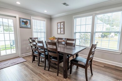 Dining space featuring wood-type flooring, ornamen