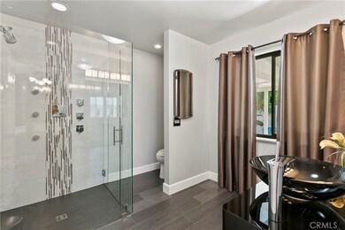 Master bath is a WOW with custom, designer details including vessel sink vanity and amazing walk-in shower with multiple shower heads.