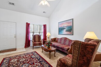 Living room with light carpet, high vaulted ceilin