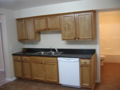 Kitchen with full bath in background