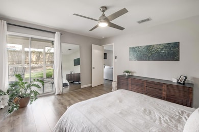 Bedroom with wood finished floors, access to exte