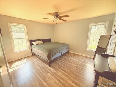 Bedroom with LVT floors and a ceiling fan- Walk-in