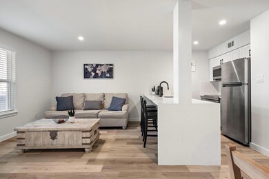 Living room with light wood-style floors, visible