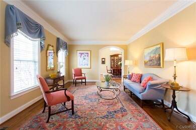 Living room looking into dining room with arched d