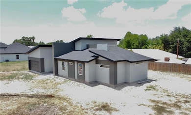 Modern home with stucco siding, a garage, and roof with shingles