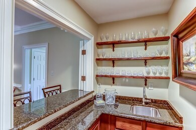 A granite wet bar with sink adjoins the Great Room