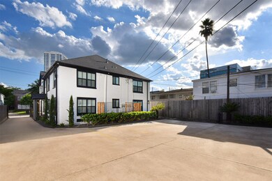 Gated driveway with ample parking spots behind the