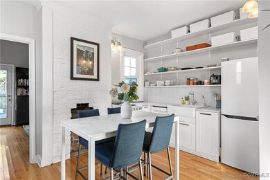 Dining area featuring a brick fireplace, sink, and