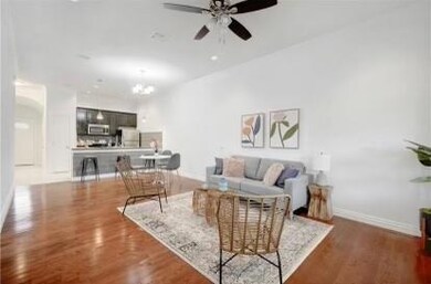 Living room featuring baseboards, wood finished f