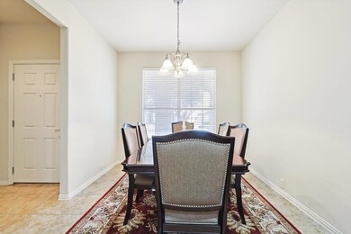 Tiled dining area featuring a notable chandelier