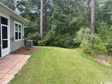 View of yard with cooling unit and a patio
