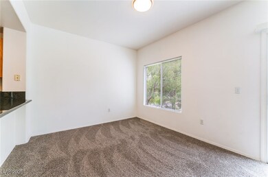 Empty room with carpet and baseboards