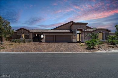 Mediterranean / spanish-style home featuring a gar
