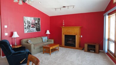 Open living room with vaulted ceiling, cozy gas fi