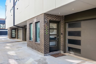 Entrance to property featuring brick siding