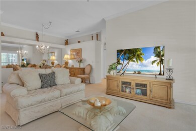 Living room featuring ornamental molding, a chande