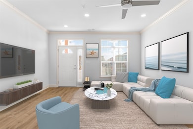 Living room with ceiling fan, ornamental molding, 