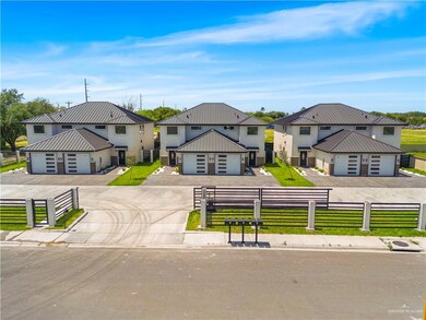 View of front of property with a front yard, metal roof, driveway, and a fenced front yard