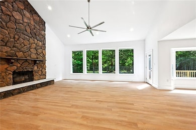 Den with wood burning fireplace