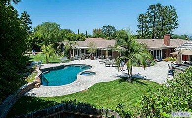 This home, with its flag-stone atrium, multitude o