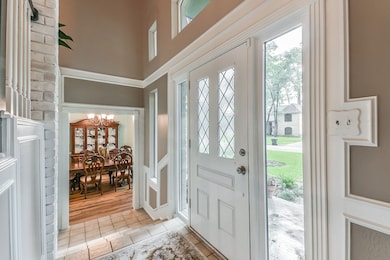 Foyer with tile flooring and vaulted ceiling and new chandelier beautiful focal point.