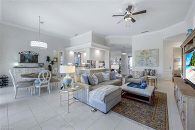 Tiled living room with ceiling fan and ornamental 