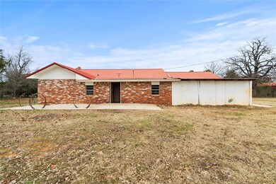 Back of house featuring a yard and a patio area