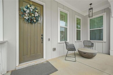 Property entrance featuring board and batten siding and covered porch