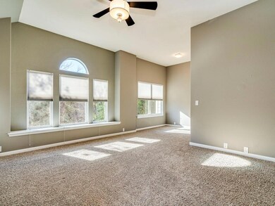 Spare room featuring baseboards, ceiling fan, and