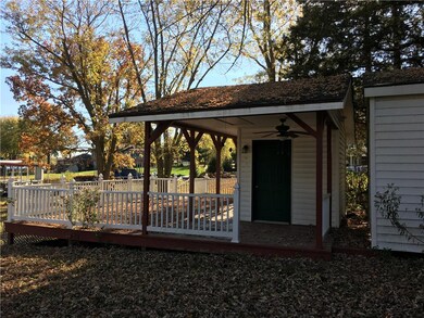 Side w/ entrance to gazebo and storage bldg.