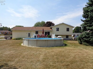 Back view, above ground pool w/cover, large deck.