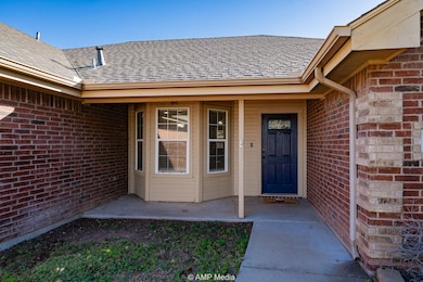 Entrance to property with brick siding and roof with shingles