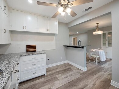 Kitchen with eat in granite countertop.