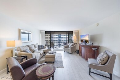 Living room featuring expansive windows and light wood-style flooring