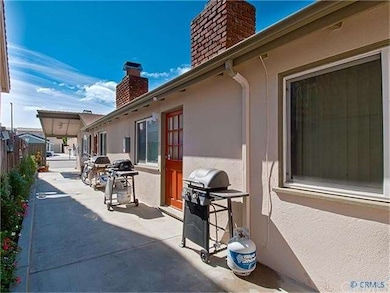 Entry side yard w/ new hardscape and great BBQ are