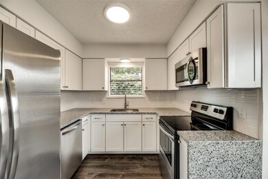 Kitchen featuring stainless steel appliances, a he