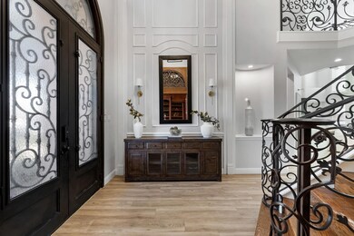 Foyer featuring stairs, french doors, light wood-s