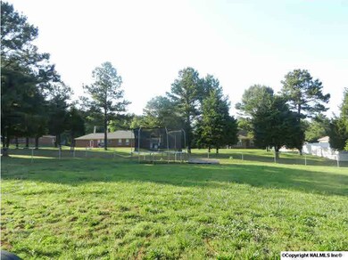 Huge fenced backyard with patio featuring a retractable awning.