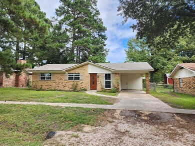 Ranch-style home featuring a carport and a front l