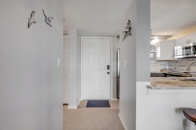 Entryway with tile patterned flooring and baseboards