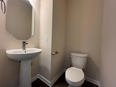 Bathroom with toilet and baseboards