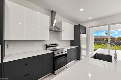 Kitchen featuring a sink, white cabinetry, wall ch