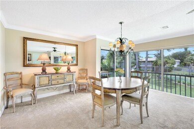 Carpeted dining room with crown molding, a textured ceiling, and a chandelier